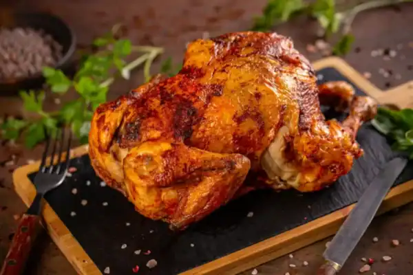 poularde au four dorée et moelleuse dans son plat avec herbes